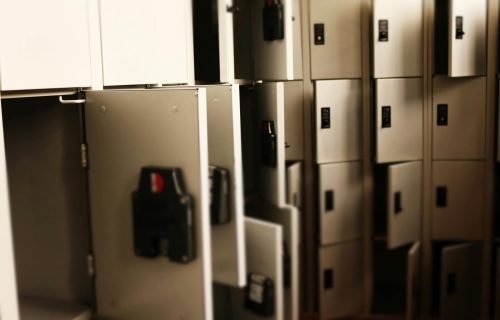 A row of open lockers in a secure indoor storage area, ideal for storing valuables.